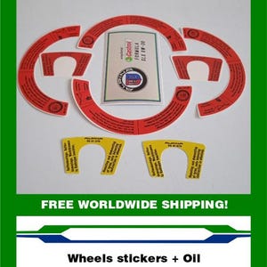 May include: A collection of red and white wheel stickers and a Castrol Formula SLX 0W-30 oil label. The stickers are in various shapes and sizes, with text. The oil label has a blue, white, and red logo.