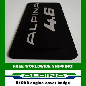 May include: Black rectangular engine cover badge with the word "ALPINA" in silver lettering and the number "4.6". The text "B10V8 engine cover badge" is also visible.