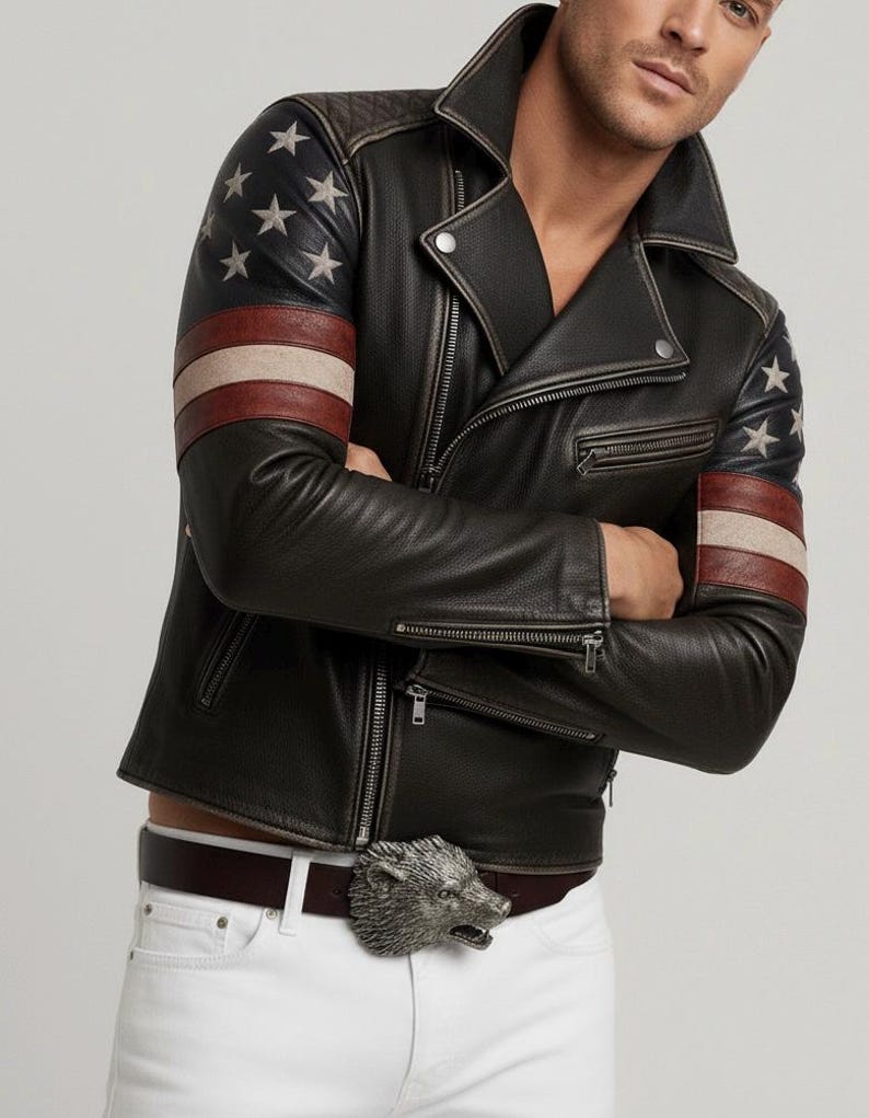 May include: Black leather jacket with American flag design on the sleeves. The jacket features a classic biker style with a notched collar, zipper closure, and a silver wolf buckle belt. The sleeves have a star and stripe design.