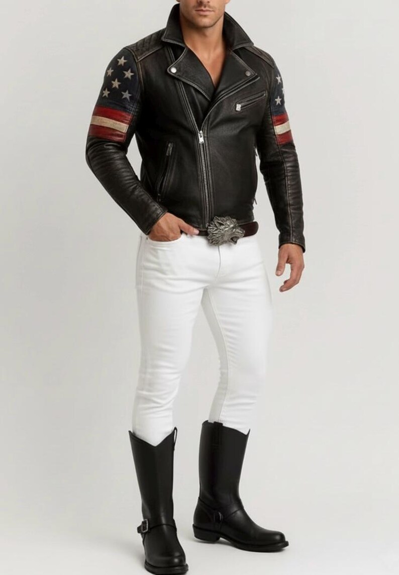 May include: Black leather jacket with American flag design on the sleeves, paired with white pants and black boots. The jacket has a zipper closure and a notched collar. A silver belt buckle adds a decorative touch.