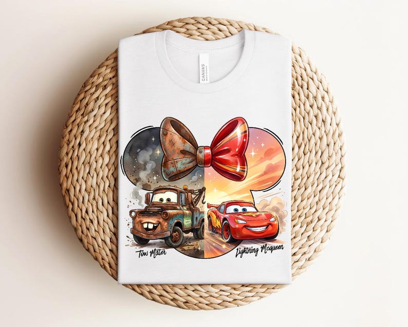 May include: A white t-shirt featuring a graphic of a bow shape containing Tow Mater on the left and Lightning McQueen on the right. The left side is brown and rustic, while the right side is bright red and orange. The names Tow Mater and Lightning McQueen are printed below the characters.