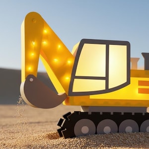 May include: A yellow toy excavator with a black tread, a gray bucket, and a cabin with a window. The excavator's arm is lit with small lights. The toy is set on a sandy surface with a blue sky background.