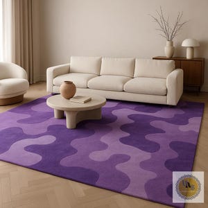 May include: A large, rectangular area rug with a wavy, abstract pattern in shades of purple. The rug is placed in a living room setting, with a cream-colored sofa and a round coffee table. The rug's design adds a modern touch to the room.
