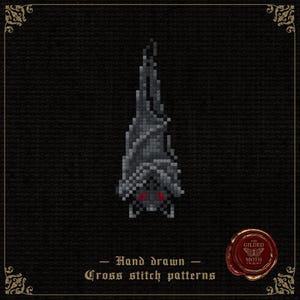 May include: A pixel art style cross stitch pattern of a grey bat hanging upside down with bright red eyes. Below the bat, the text reads Hand drawn Cross stitch patterns. A red wax seal logo with the text The Gilded Moth is in the bottom corner.