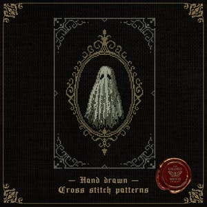 May include: Cross-stitch pattern featuring a pixelated ghost within an ornate oval frame. The design is in shades of gray and white against a black background, with decorative corner elements. Text reads "Hand drawn - Cross stitch patterns".