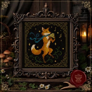 May include: Cross-stitch artwork featuring a dancing fox with a blue scarf, holding flowers and musical notes, in a decorative black frame. The design is set against a dark background with floral accents and a gold border. The Gilded Moth logo is visible.