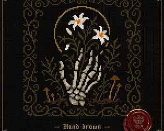 May include: Cross-stitch pattern featuring a skeletal hand holding white flowers with orange centers, set against a black background. The design includes a gold halo, brown mushrooms, and decorative borders. Text reads "Hand drawn Cross stitch patterns".