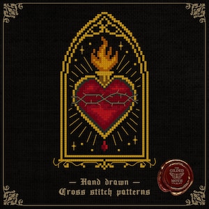 May include: A cross-stitch pattern featuring a red heart pierced by a crown of thorns, topped with a flame, within a gold-colored arched frame. The design includes the text "Hand drawn Cross stitch patterns" on a black background.