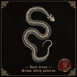 May include: A cross-stitch pattern featuring a snake skeleton in off-white against a black background. The design includes the text "Hand drawn - Cross stitch patterns" and a circular emblem. The overall aesthetic is gothic and detailed.