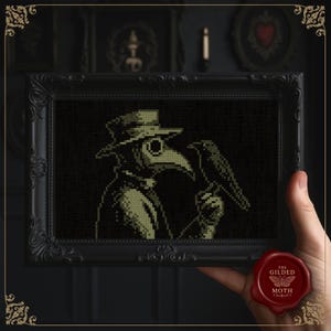 May include: A framed cross-stitch artwork featuring a plague doctor holding a raven. The artwork is in shades of green and black, set in a black ornate frame. The artwork is held by a hand, with a red wax seal in the lower right corner.