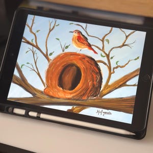 May include: Digital painting of a bird perched on a nest in a tree. The bird is orange and red, the nest is brown, and the background is a light blue sky. The artwork is displayed on a tablet with a stylus.