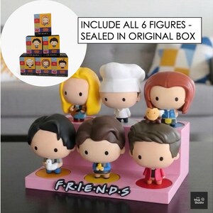 May include: A display of six Friends character figurines on a pink stand with the show's logo. The figurines have large heads and are in various outfits. The text reads: "INCLUDE ALL 6 FIGURES - SEALED IN ORIGINAL BOX."