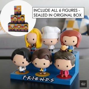 May include: A set of six Friends character figurines displayed on a blue base with the show's logo. The figurines are in a cartoon style, each with unique outfits and hairstyles. The text "INCLUDE ALL 6 FIGURES - SEALED IN ORIGINAL BOX" is visible.
