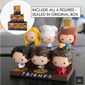 May include: A set of six Friends character figurines displayed on a brown stand. Each figure has a unique hairstyle and outfit. The stand has the show's logo, "F.R.I.E.N.D.S." in white. The text "INCLUDE ALL 6 FIGURES - SEALED IN ORIGINAL BOX" is also visible.