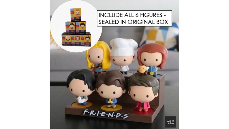 May include: A set of six Friends character figurines displayed on a brown stand. Each figure has a unique hairstyle and outfit. The stand has the show's logo, "F.R.I.E.N.D.S." in white. The text "INCLUDE ALL 6 FIGURES - SEALED IN ORIGINAL BOX" is also visible.