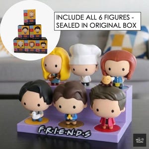 May include: A set of six Friends character figurines displayed on a purple stand with the show's logo. The figurines are in a cartoon style, with the text "INCLUDE ALL 6 FIGURES - SEALED IN ORIGINAL BOX" in the background.