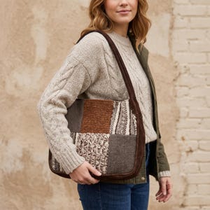 May include: A patchwork shoulder bag with a brown suede trim and strap. The bag features squares of various textured fabrics in shades of brown, gray, and cream. The bag is being carried over the shoulder.