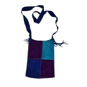 May include: A small, patchwork suede bag with a blue strap. The bag is made of four squares of suede in shades of blue and purple.