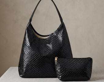 May include: A black hobo bag and a matching small zipped pouch, both featuring a glossy, textured snakeskin-like pattern. The hobo bag has a single shoulder strap and a wide opening, while the rectangular pouch includes a gold-toned zip fastener.