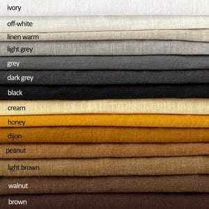 May include: A close-up of various linen fabric swatches in a range of colors. The colors include ivory, off-white, linen warm, light grey, grey, dark grey, black, cream, honey, dijon, peanut, light brown, walnut, and brown.