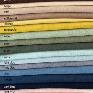 May include: A fabric color swatch card featuring a variety of colors, including ivory, black, and shades of grey, brown, and blue. The card displays the names of the colors, such as "honey", "denim", and "red berry".