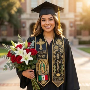 May include: A person in a black graduation gown and cap, holding a bouquet of red roses and white lilies. The gown has a gold-trimmed sash with the text "Class of 2026", a cross, and the Mexican flag. The sash also has the name "Elisa Ramirez" and the words "City High School".