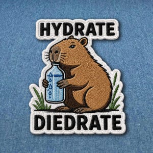May include: Embroidered patch featuring a brown capybara holding a water bottle. The patch has the words "HYDRATE" above the capybara and "DIEDRATE" below. The patch is outlined in white with green grass accents.