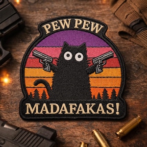 May include: Embroidered patch featuring a black cat holding two guns against a sunset backdrop. The patch reads "PEW PEW MADAFAKAS!" in a stylized font, with a black border and a forest silhouette at the bottom.