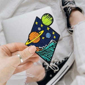 May include: A set of three ceramic mugs with a speckled, matte finish. The mugs are in shades of cream, light gray, and dark gray. Each mug has a simple, minimalist design, perfect for coffee or tea.