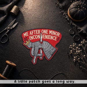 May include: Embroidered patch with the text "ME AFTER ONE MINOR INCONVENIENCE" on a red background. The patch features a cartoon knight with a sword through its head. The phrase "A little patch goes a long way" is at the bottom.