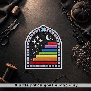 May include: Embroidered patch featuring a colorful staircase design against a starry night sky, with a crescent moon and stars. The patch has a rainbow color scheme and the text "A little patch goes a long way."