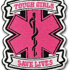 May include: Embroidered patch featuring a pink Star of Life emblem with a black staff and serpent. The patch has the text "TOUGH GIRLS" above and "SAVE LIVES" below, both in pink lettering on white banners, outlined in black.