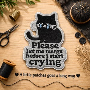May include: Embroidered patch featuring a black cat with blue tear drops, and the text "Please let me merge before I start crying." The patch is surrounded by a gray border. The phrase "A little patches goes a long way" is also included.