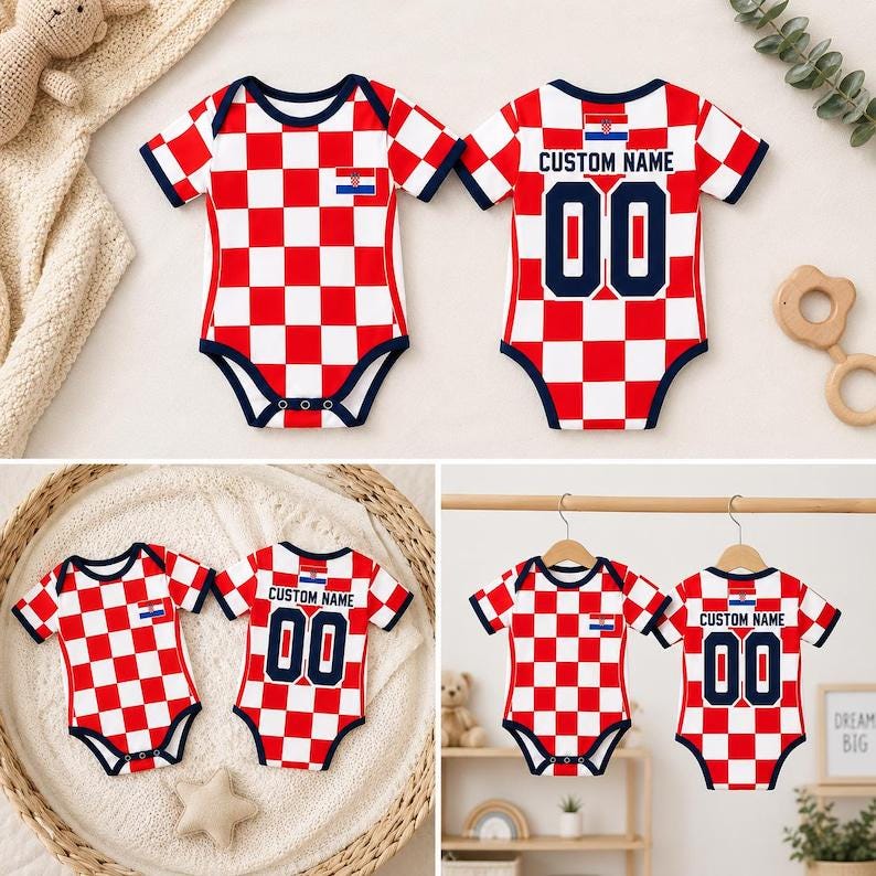 May include: A short-sleeved baby bodysuit featuring a red and white checkered pattern, navy blue trim, and the Croatian flag emblem. The back displays the text CUSTOM NAME above the number 00 in navy blue, with a small Croatian flag above the text.