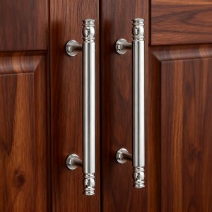 May include: Two vertical polished chrome cabinet pulls with a cylindrical bar design and decorative rounded finials at the top and bottom. Each handle is mounted to a dark brown wood cabinet door with two circular bases, featuring a reflective finish.