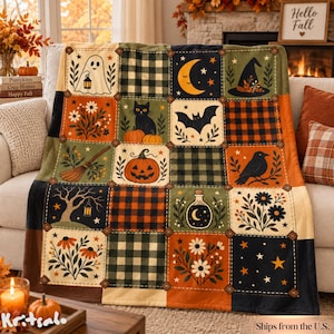 May include: A patchwork throw blanket featuring a grid of squares with Halloween-themed illustrations including a ghost, black cat, jack-o'-lantern, bat, witch hat, crescent moon, crow, potion bottle, and various floral patterns in orange, black, and cream.