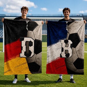May include: Two rectangular fleece blankets featuring soccer ball patterns and national flag designs. One blanket displays the black, red, and gold German flag with a large letter D, while the other shows the blue, white, and red French flag with a letter B.