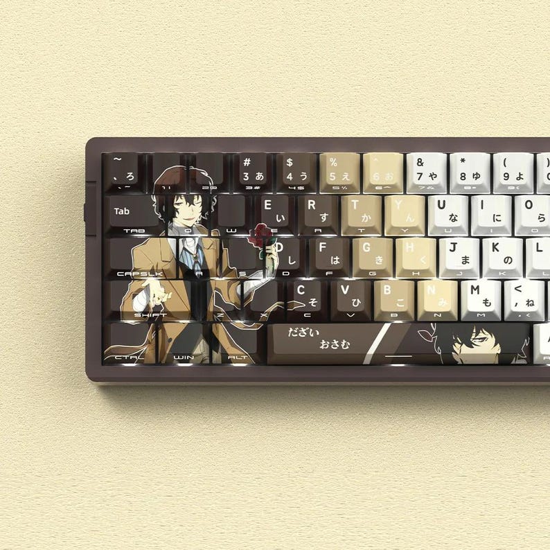 May include: A custom keyboard with keycaps featuring anime character art. The keycaps are a mix of brown, beige, and white, with Japanese characters and English letters. The keyboard has a brown frame.