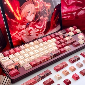 May include: A mechanical keyboard with red and cream-colored keycaps. The keyboard has a burgundy frame and features custom keycaps with Japanese-inspired designs. A tablet displaying anime art is in the background.