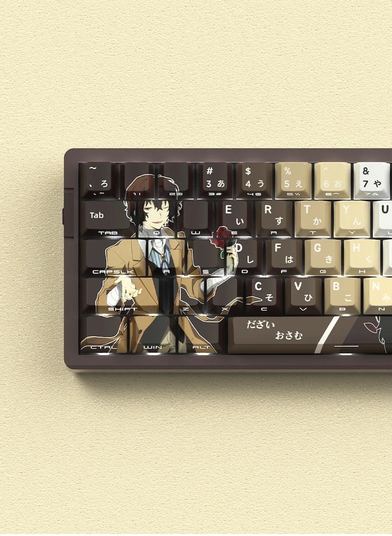 May include: A custom mechanical keyboard with keycaps featuring an anime character illustration. The keycaps are brown, beige, and white with Japanese characters and English letters. The keyboard has a dark brown frame.