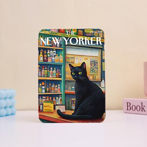 May include: A rectangular metal sign featuring a reproduction of The New Yorker magazine cover from January 14, 1973. The illustration depicts a black cat sitting on a counter in front of shelves filled with various colorful bottles and containers.