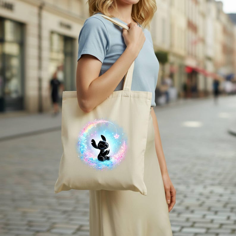 "Ready to press DTF transfer featuring a galaxy-themed Stitch silhouette with glowing colorful aura for custom tote bag printing."