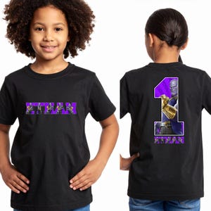 May include: Black t-shirt with the name "ETHAN" in purple block letters across the front. The back of the shirt features a large purple number "1" with a Thanos graphic and the name "ETHAN" in purple.