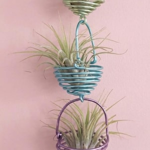 May include: A white ceramic mug with a black handle and the text "But First, Coffee" in a black, bold font. The mug is on a white surface.