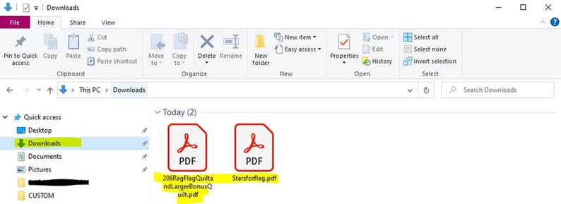 May include: A screenshot of a Windows computer showing the Downloads folder with two PDF files: "206RagFlagQuilta ndLargerBonusQuilt.pdf" and "Starsforflag.pdf".