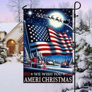 May include: A garden flag depicting the American flag in a winter scene, with Santa's sleigh and the text "WE WISH YOU AMERI CHRISTMAS". The flag is on a black pole, set against snow-covered trees and houses.