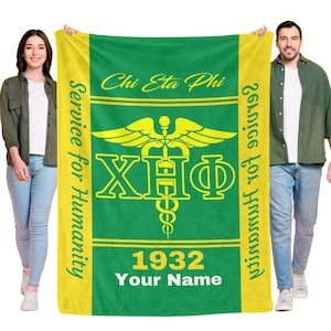 Può includere: Coperta verde e gialla con la scritta "Chi Eta Phi" e "Service for Humanity". La coperta presenta un simbolo medico con le lettere X, H e Φ. Sono visualizzati anche l'anno 1932 e le parole "Your Name".