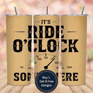 May include: A beige tumbler with a black design that reads "IT'S RIDE O'CLOCK SOMEWHERE" with a speedometer graphic. The tumbler has a silver lid and straw. A circular sticker at the bottom says "Buy 1 Get 9 Free Designs."