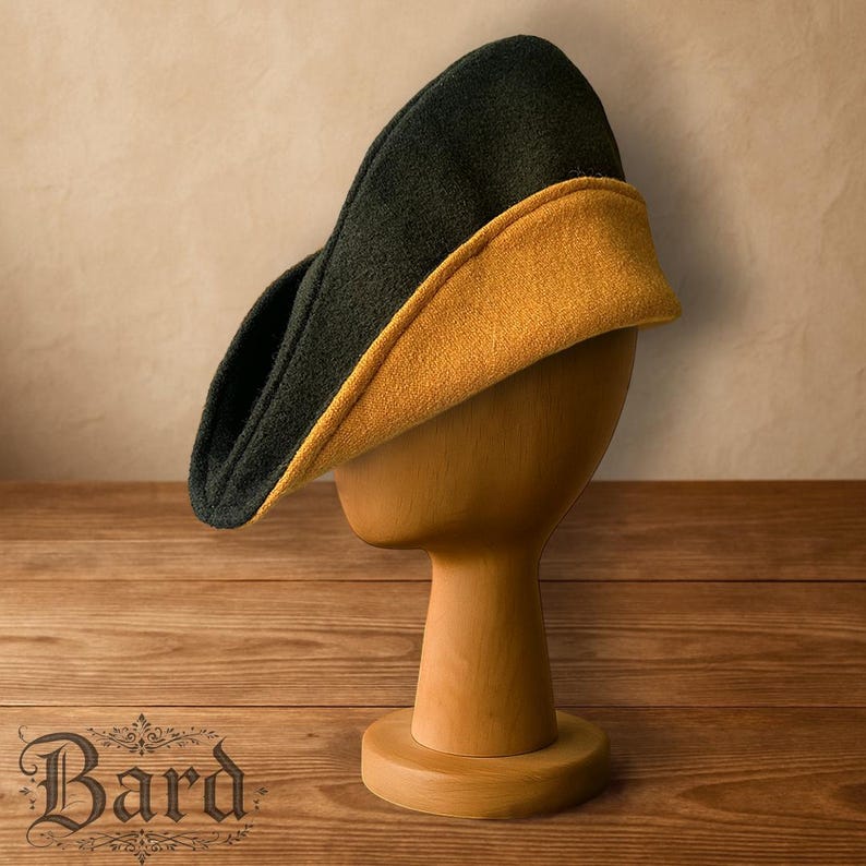May include: A two-tone hat, with a dark green exterior and a mustard yellow interior, is displayed on a wooden head form. The hat has a curved, asymmetrical shape. The word "Bard" is visible in the lower left corner.