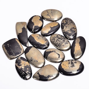 May include: A collection of polished pyrite stones, also known as fool's gold, in various shapes. The stones have a metallic gold color with dark grey and black patches. The shapes include oval, rectangular, and irregular forms, all with a smooth, reflective surface.